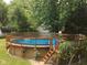 Backyard pool with wooden deck and railing at 8120 Trevellian Way, Indianapolis, IN 46217