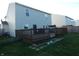 A well-maintained backyard featuring a spacious wooden deck, lush green lawn, and partial fence at 8609 Wheatfield Dr, Camby, IN 46113