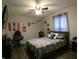 This bedroom features a ceiling fan, decor, a comfortable-looking bed, and a large TV at 8609 Wheatfield Dr, Camby, IN 46113