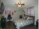 Comfortable bedroom with wood floors, ceiling fan, decorative wall art, and plenty of space for relaxation at 8609 Wheatfield Dr, Camby, IN 46113