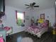 Cozy bedroom featuring a colorful bed, a desk area, and a ceiling fan for added comfort at 8609 Wheatfield Dr, Camby, IN 46113