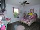 Cozy bedroom featuring a colorful bed, a desk area, and a ceiling fan for added comfort at 8609 Wheatfield Dr, Camby, IN 46113