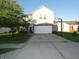 Two-story home featuring a brick and vinyl facade, attached garage, and a basketball hoop in the driveway at 8609 Wheatfield Dr, Camby, IN 46113