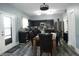 Well-lit kitchen featuring stainless steel appliances, dark wood cabinets, and a dining area perfect for Gathering meals at 8609 Wheatfield Dr, Camby, IN 46113