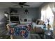 A modern living room featuring couches, a ceiling fan, a TV, and light-blue paint at 8609 Wheatfield Dr, Camby, IN 46113