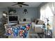 A modern living room featuring couches, a ceiling fan, a TV, and light-blue paint at 8609 Wheatfield Dr, Camby, IN 46113