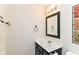 A bathroom with dark wood vanity and framed mirror at 8713 Champions Dr, Indianapolis, IN 46256