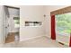 Bedroom with a view of the kitchen through a serving hatch, with natural light from the windows at 8713 Champions Dr, Indianapolis, IN 46256