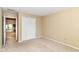 A bright bedroom with closet, neutral carpet, and view into adjacent rooms at 8713 Champions Dr, Indianapolis, IN 46256