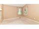 Neutral bedroom with carpet flooring and two windows, creating a calm and inviting space at 8713 Champions Dr, Indianapolis, IN 46256