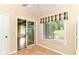This light filled breakfast nook features a high ceiling, and views of the backyard and enclosed patio at 8713 Champions Dr, Indianapolis, IN 46256