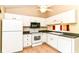 Bright kitchen features white cabinets, modern appliances, and a window over the sink at 8713 Champions Dr, Indianapolis, IN 46256