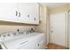 Convenient laundry room with washer, dryer, and storage cabinets at 8713 Champions Dr, Indianapolis, IN 46256