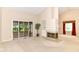 Living room with large windows, a fireplace and a door leading to a sunroom at 8713 Champions Dr, Indianapolis, IN 46256
