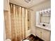 Bathroom featuring a tub and shower combo, vanity, mirror, and decorative shower curtain at 901 Columbia Ave, Alexandria, IN 46001