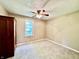 This bedroom features neutral paint, carpeted floor, a window and a ceiling fan at 901 Columbia Ave, Alexandria, IN 46001