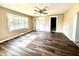 Spacious living room featuring updated flooring, natural light, and a classic ceiling fan at 901 Columbia Ave, Alexandria, IN 46001