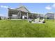 Spacious backyard with patio featuring a grilling area, a fire pit, and ample seating, perfect for gatherings at 998 Cherry Tree Ln, Greenwood, IN 46143