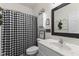 Stylish bathroom with a black and white checkered shower curtain and a modern vanity with a quartz countertop at 998 Cherry Tree Ln, Greenwood, IN 46143
