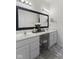 Elegant bathroom features double sinks, a vanity area, and a large framed mirror for a spa-like experience at 998 Cherry Tree Ln, Greenwood, IN 46143
