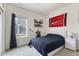 Cozy bedroom with a plush navy comforter, a nightstand, and a bright window at 998 Cherry Tree Ln, Greenwood, IN 46143