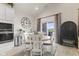 Bright dining room features a stylish round table, white chairs, and sliding glass doors to outdoor views at 998 Cherry Tree Ln, Greenwood, IN 46143