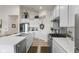 Modern kitchen features white cabinetry, stainless steel appliances, and ample counter space for cooking and entertaining at 998 Cherry Tree Ln, Greenwood, IN 46143