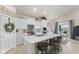Open kitchen with island seating, stainless appliances, and a dining area with sliding glass doors at 998 Cherry Tree Ln, Greenwood, IN 46143