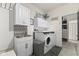 Functional laundry room with washer, dryer, sink, and plenty of storage cabinets for cleaning supplies at 998 Cherry Tree Ln, Greenwood, IN 46143