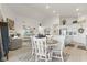 Open-concept living space boasts vaulted ceilings, neutral decor, and seamless flow to kitchen and dining areas at 998 Cherry Tree Ln, Greenwood, IN 46143