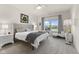 Serene main bedroom with plush carpeting, neutral tones, and a large window overlooking the backyard at 998 Cherry Tree Ln, Greenwood, IN 46143