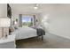Bright main bedroom features a ceiling fan, plush carpeting, and a large window with tranquil backyard views at 998 Cherry Tree Ln, Greenwood, IN 46143