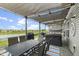 Inviting covered patio with outdoor dining, hot tub, grill, and view of the water offers relaxed entertaining at 998 Cherry Tree Ln, Greenwood, IN 46143