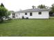 Large grassy backyard featuring a fenced-in space for privacy and an air conditioning unit at 1021 Harney Dr, Lebanon, IN 46052