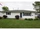 Charming single-story home featuring white siding, blue shutters and door, and a well-maintained lawn at 1021 Harney Dr, Lebanon, IN 46052