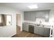 Bright kitchen with gray cabinetry, stainless steel appliances, and wood-look flooring at 1021 Harney Dr, Lebanon, IN 46052