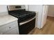 A stainless steel gas range with granite countertops is adjacent to a refrigerator at 1021 Harney Dr, Lebanon, IN 46052