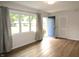 Bright and open living room with hardwood floors, large windows, and a view of the front yard at 1021 Harney Dr, Lebanon, IN 46052
