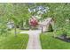 Aerial view of the lovely two-story brick home with beautiful landscaping and an attached three car garage at 10697 Woodmont Ln, Fishers, IN 46037
