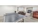 Finished basement with ping pong table, bar area, and cozy seating at 10697 Woodmont Ln, Fishers, IN 46037