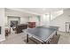 Finished basement featuring a ping pong table, bar, and cozy seating area at 10697 Woodmont Ln, Fishers, IN 46037