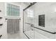 Modern bathroom features a glass enclosed shower with a black frame and marbled tile at 10697 Woodmont Ln, Fishers, IN 46037