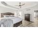 Spacious primary bedroom with tray ceilings and a view to the ensuite bath at 10697 Woodmont Ln, Fishers, IN 46037