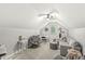 Upstairs bonus room featuring a comfortable sitting area, desk, and grey carpet at 10697 Woodmont Ln, Fishers, IN 46037