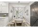 Charming dining area with farmhouse table, modern lighting, and decor at 10697 Woodmont Ln, Fishers, IN 46037