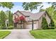 Lovely two-story brick home featuring an attached three car garage, basketball hoop and beautiful landscaping at 10697 Woodmont Ln, Fishers, IN 46037