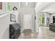 The foyer showcases a two-story ceiling, elegant decor, and a beautiful front door with glass inserts at 10697 Woodmont Ln, Fishers, IN 46037