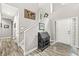 The spacious foyer showcases a two-story ceiling and elegant decor with wood flooring at 10697 Woodmont Ln, Fishers, IN 46037