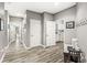 Hallway features hardwood floors with neutral gray colored walls at 10697 Woodmont Ln, Fishers, IN 46037