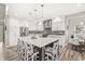 This modern kitchen features an island with seating, pendant lights, and stainless steel appliances at 10697 Woodmont Ln, Fishers, IN 46037